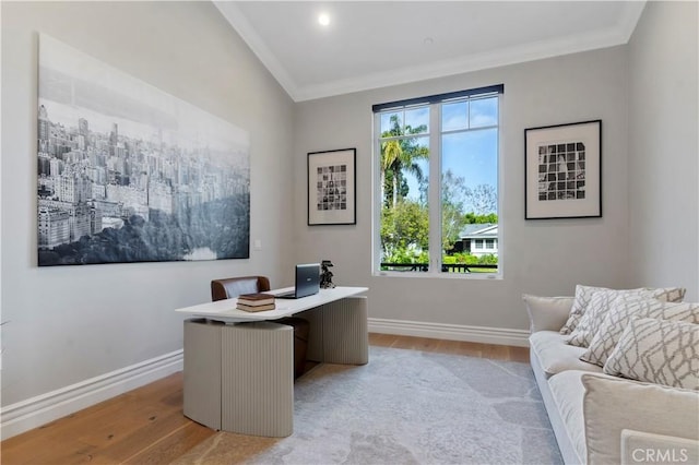 office area with light wood-type flooring and crown molding