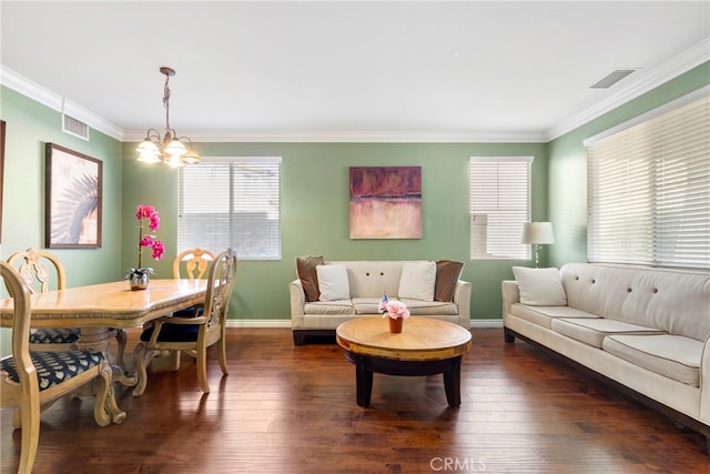 living room with an inviting chandelier, crown molding, and dark hardwood / wood-style flooring