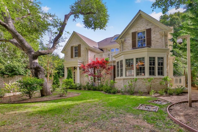 back of house with a lawn