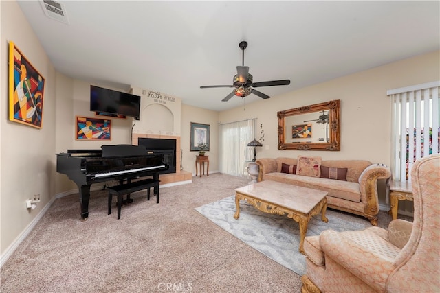 carpeted living room with ceiling fan and plenty of natural light