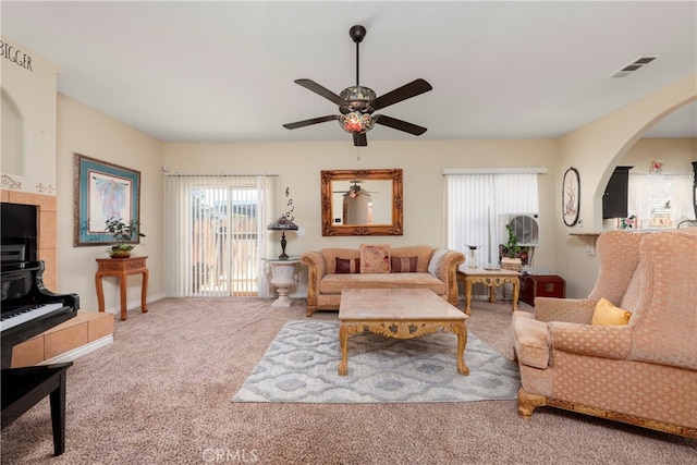 carpeted living room featuring ceiling fan