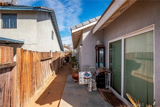 view of side of home featuring central AC unit and a patio area