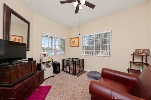 living room with ceiling fan and light colored carpet