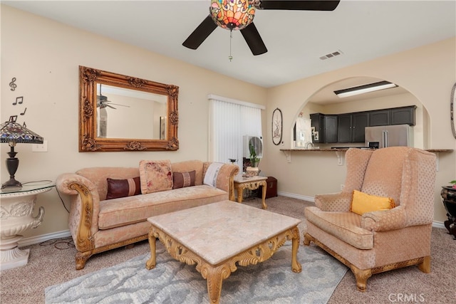 living room with carpet and ceiling fan