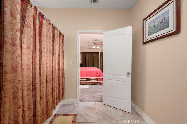 hall with light tile patterned floors