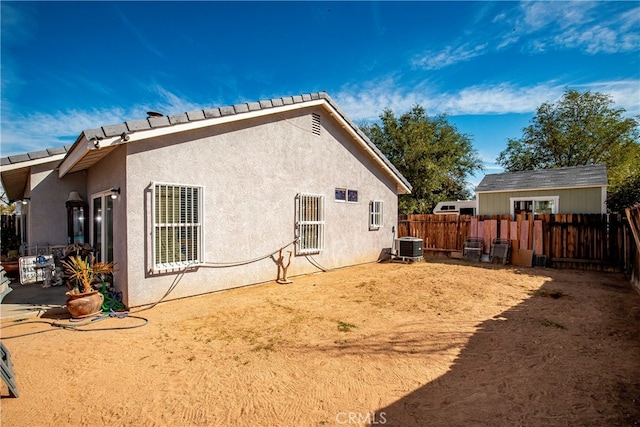 back of house with central air condition unit