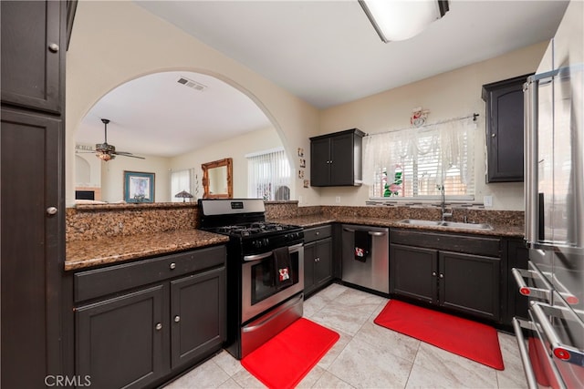 kitchen with appliances with stainless steel finishes, a healthy amount of sunlight, ceiling fan, and sink