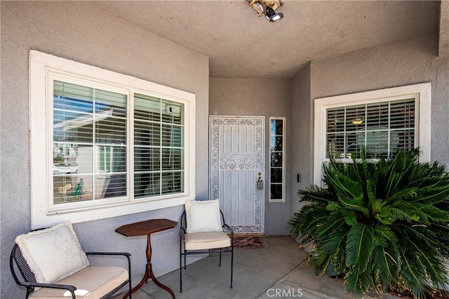 property entrance featuring a patio area