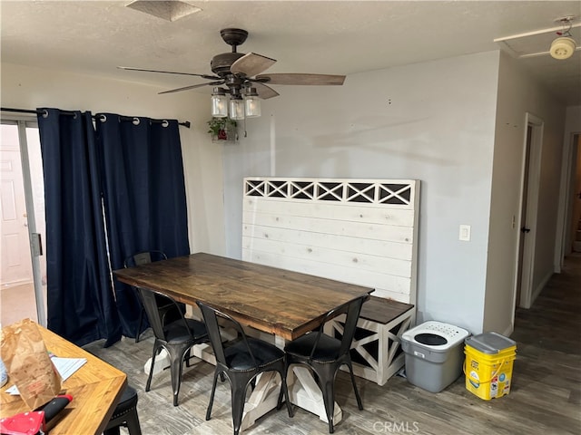 dining space with wood-type flooring and ceiling fan