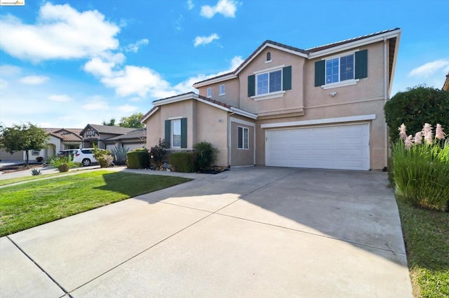 front of property featuring a front yard and a garage