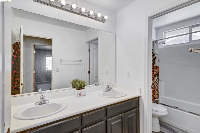 full bathroom featuring shower / bath combo, vanity, hardwood / wood-style flooring, and toilet