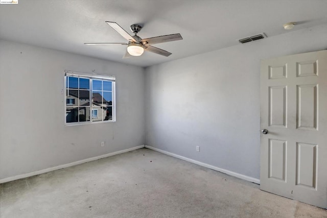 spare room with light carpet and ceiling fan