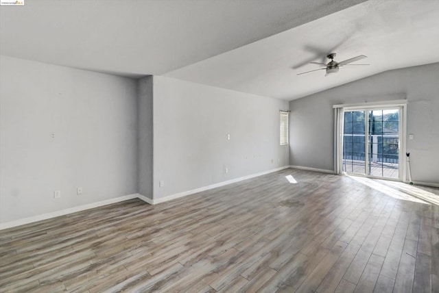 empty room featuring ceiling fan, light hardwood / wood-style floors, and lofted ceiling