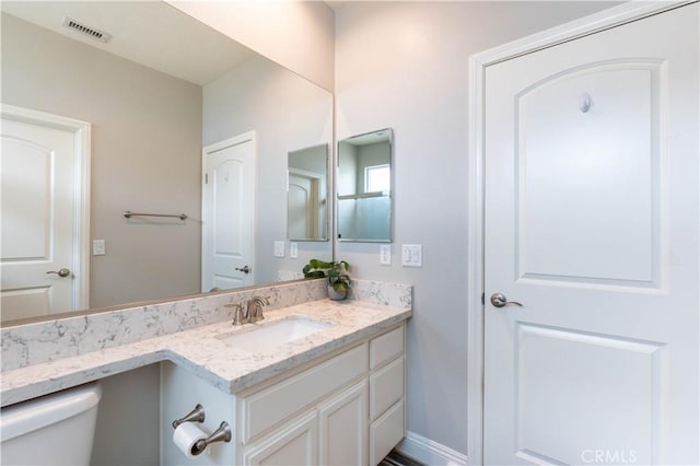 bathroom featuring vanity and toilet