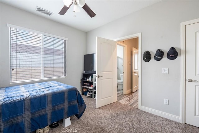 bedroom featuring ceiling fan, carpet flooring, and ensuite bath