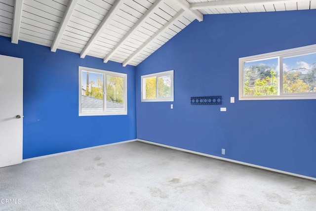 carpeted empty room featuring lofted ceiling with beams and wood ceiling