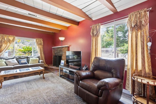 living room featuring hardwood / wood-style floors and vaulted ceiling with beams