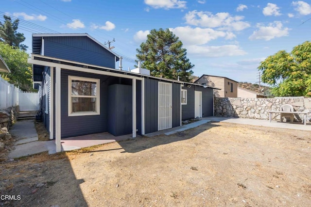 rear view of property featuring a patio area