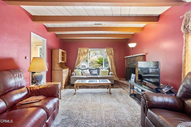 living room featuring hardwood / wood-style flooring and beam ceiling