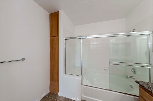 bathroom featuring tile patterned floors, shower / bath combination with glass door, and vanity