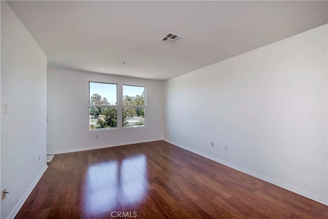 spare room featuring dark hardwood / wood-style flooring