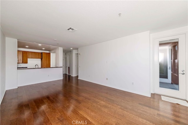 unfurnished living room featuring hardwood / wood-style flooring