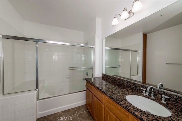 bathroom with enclosed tub / shower combo, vanity, and tile patterned floors