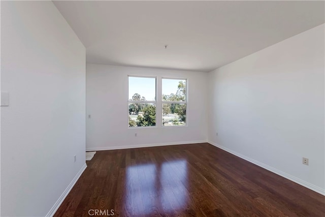 spare room featuring dark hardwood / wood-style floors