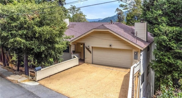 view of front facade featuring a mountain view and a garage