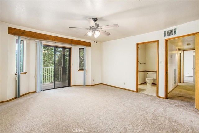 spare room featuring light carpet and ceiling fan