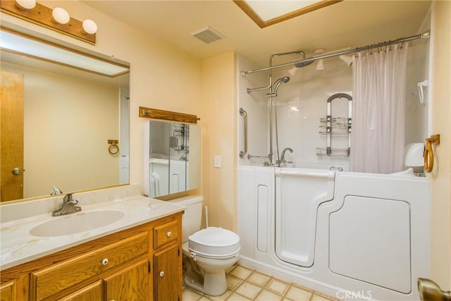 bathroom with vanity, a shower with shower curtain, and toilet