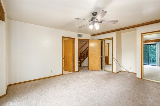 unfurnished bedroom with carpet floors and ceiling fan