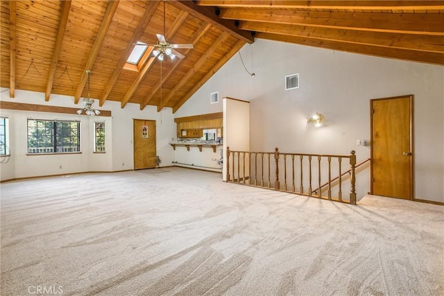 unfurnished living room with beam ceiling, a skylight, ceiling fan, high vaulted ceiling, and carpet