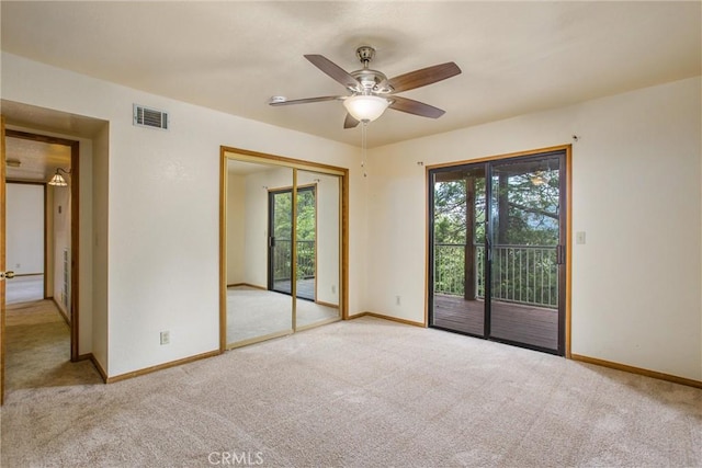 carpeted empty room with ceiling fan and a healthy amount of sunlight