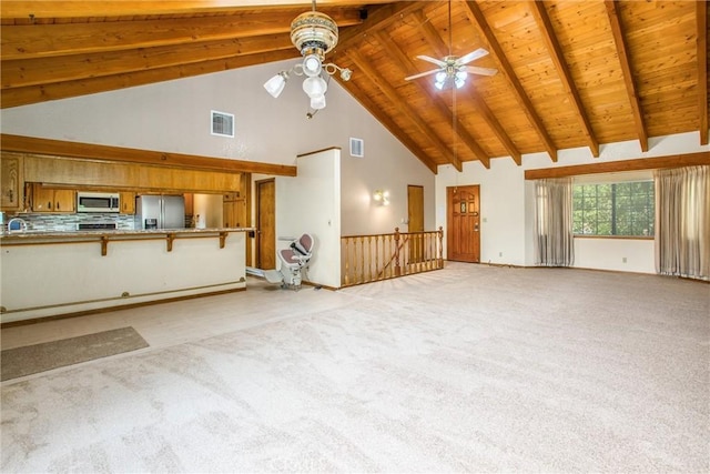 unfurnished living room with light carpet, ceiling fan, beam ceiling, high vaulted ceiling, and wooden ceiling