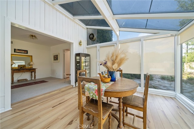 sunroom with vaulted ceiling with beams