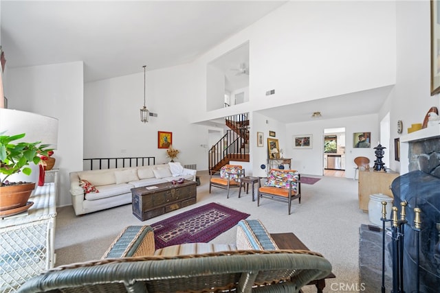 living room featuring ceiling fan, carpet flooring, and high vaulted ceiling