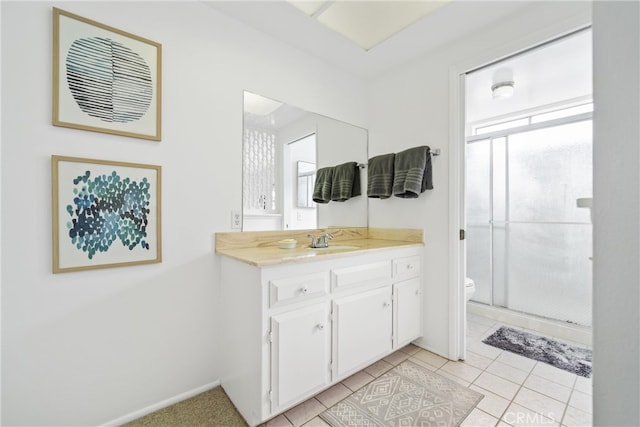 bathroom with vanity, tile patterned flooring, toilet, and an enclosed shower