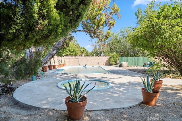 view of swimming pool featuring a patio area