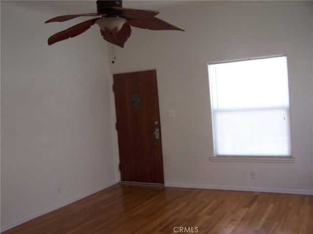 empty room featuring dark hardwood / wood-style floors and ceiling fan