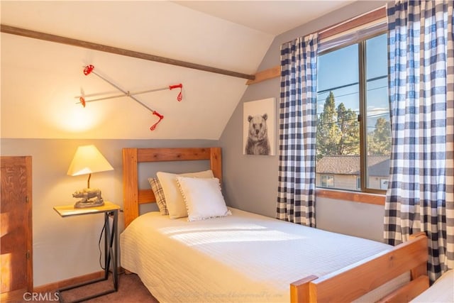 carpeted bedroom with vaulted ceiling