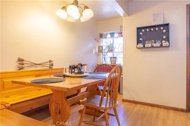 dining area featuring a chandelier and wood-type flooring