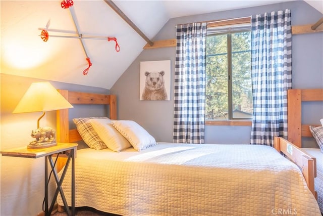 bedroom with multiple windows and lofted ceiling