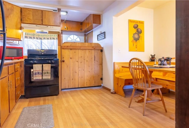 kitchen featuring black appliances and light hardwood / wood-style floors