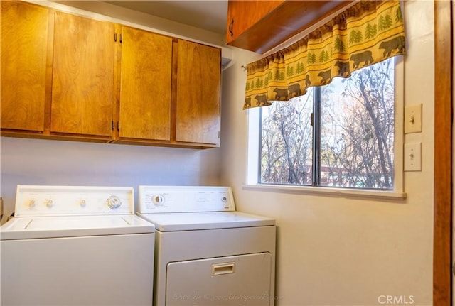 washroom featuring separate washer and dryer and cabinets