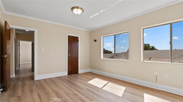 unfurnished bedroom with light hardwood / wood-style floors and crown molding