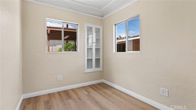 spare room with light hardwood / wood-style floors and ornamental molding