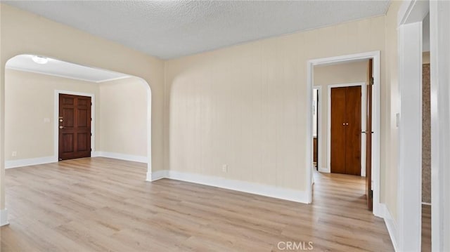 empty room featuring light hardwood / wood-style floors and a textured ceiling