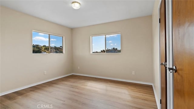 unfurnished room with light hardwood / wood-style floors