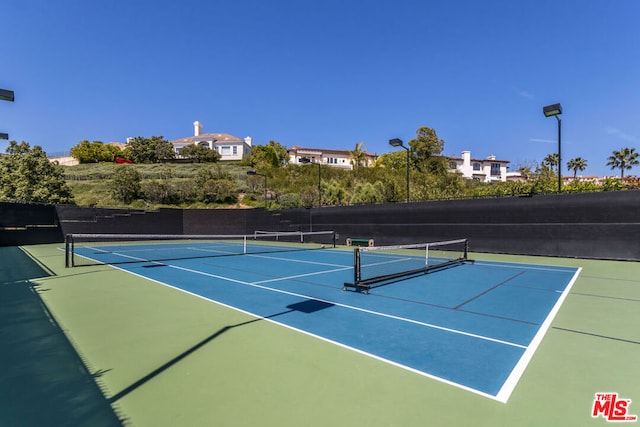 view of tennis court with basketball hoop